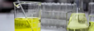 two different beakers with chemical ingredients for personal care formulations